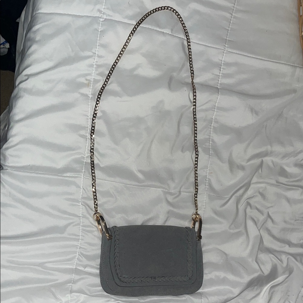 Gray cross body bag with gold-colored chain strap